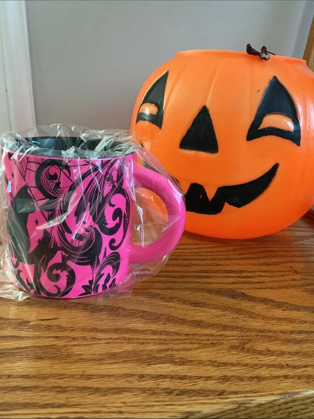 Starbucks Halloween 2021 neon pink coffee mug features a bold black cat-spider.